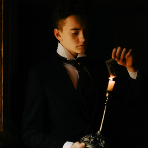A magician holding a lit candle
