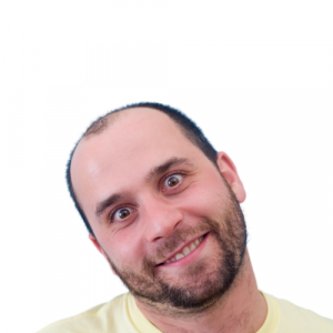 A picture of a guy, grinning and with his head tilted to the side