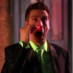A picture of a man pulling a light from his nose