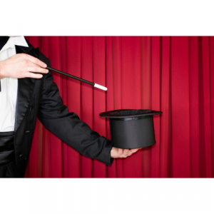 A magician pointing a wand at a top hat
