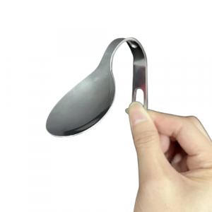 A picture of a hand holding a bent spoon