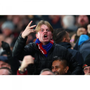 A picture of a football hooligan making rude hand gestures