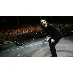 A picture of Ozzy Osbourne on stage making a funny face