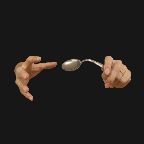 A pair of hands bending a spoon