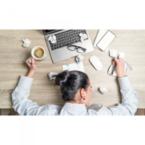 A picture of a woman laying her head on her desk.