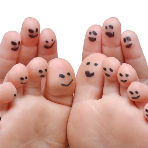 A picture of toes with smiley faces drawn on them