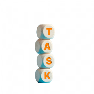 Wooden blocks with letters on them, they're stacked to read the word TASK.
