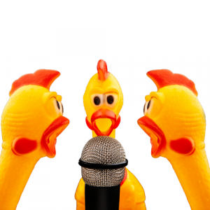 A picture of rubber chickens at a microphone