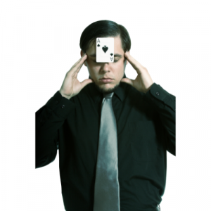 A picture of a magician with a playing stuck to his forehead.